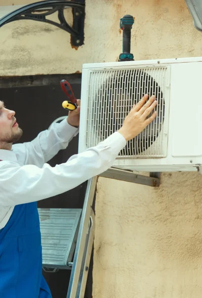 Certified HVAC technician performing repair and diagnostic service on an outdoor unit in Maui